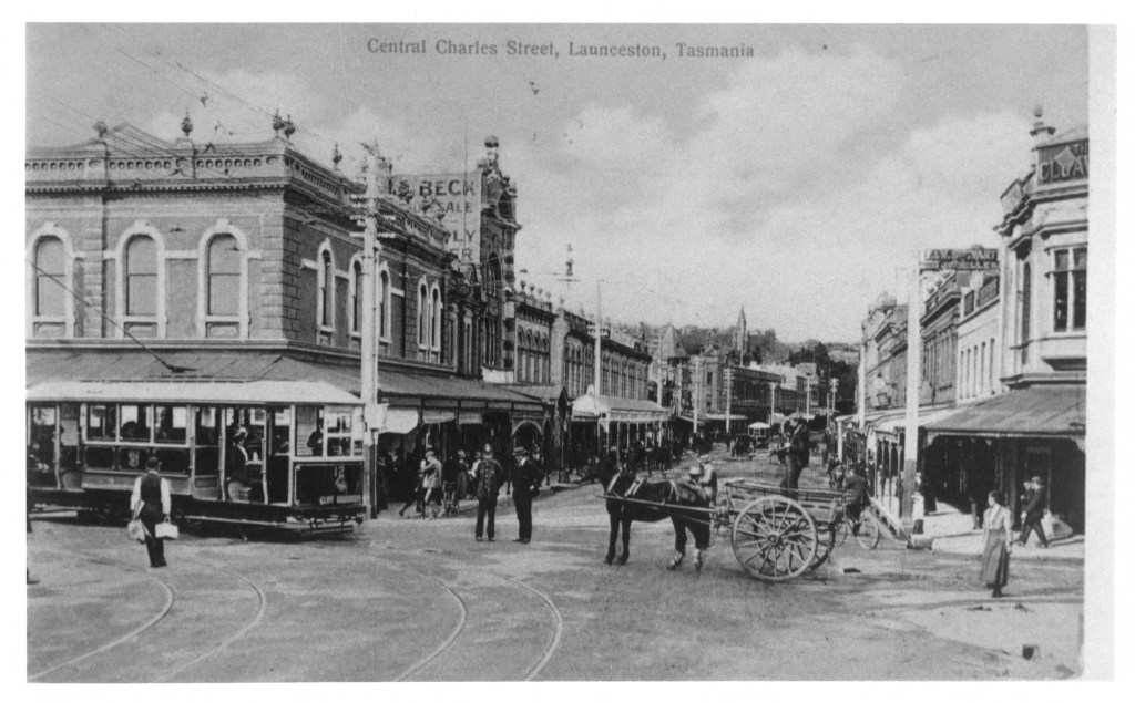 Early twentieth century photograph of Charles Street, Launceston, featuring a tram and horse drawn carts. Reflects the busy streets where a runaway horse caused chaos in 1952.